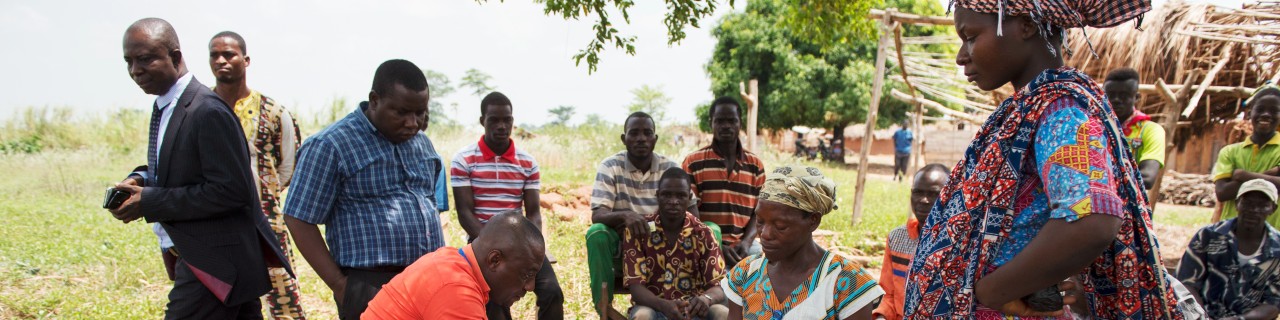 The cashier at the local bank pays out government social grants to farmers in the village of Adukram, Ashanti Region, Ghana, via e-zwich.